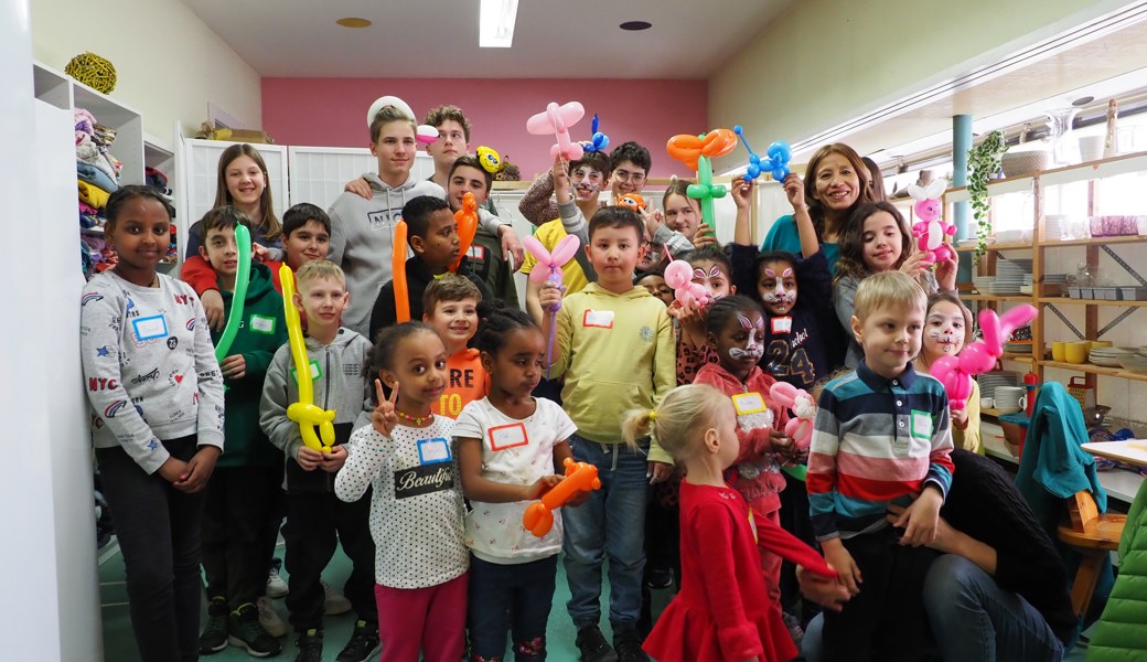 Freude herrscht: die Kinder mit den betreuenden Bregenzer Gymnasiasten (hinten) und Ballonkünstlerin Eneida Mazzola (hinten rechts. Bild: Thomas Widmer