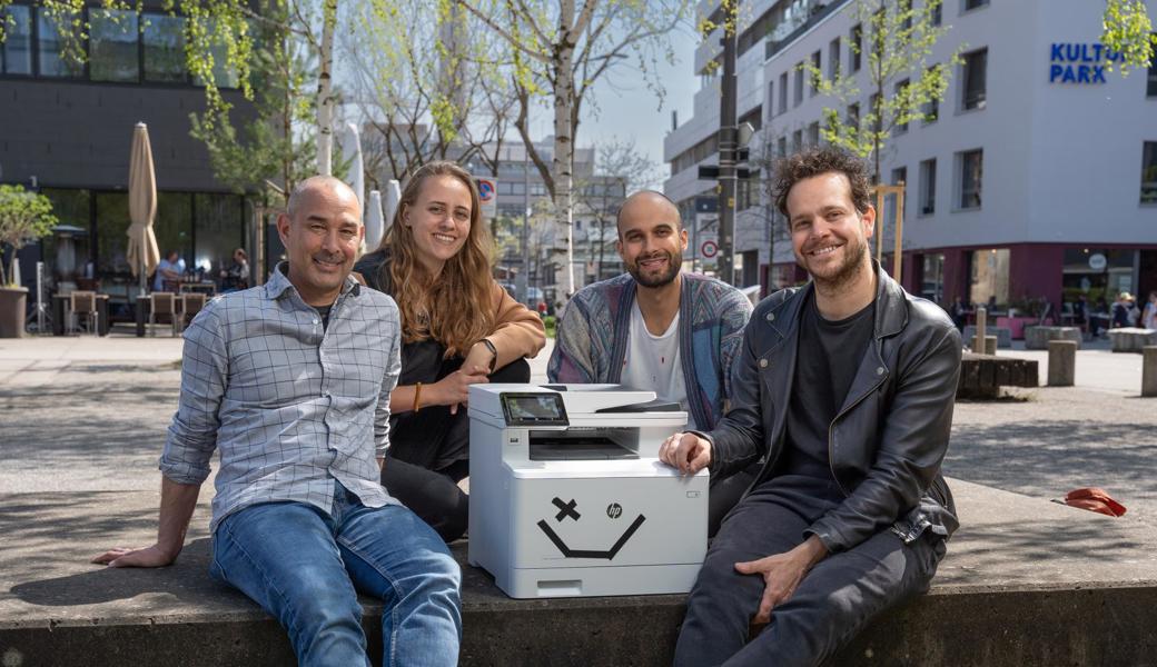 Das Loopia-Gründungsteam (v. l.): Peter Moser (CTO), Cristiana Grossenbacher (CMO), Philipp Glauser (CEO) und Tim Heeb (CPO). Der Drucker ist ihr Maskottchen.