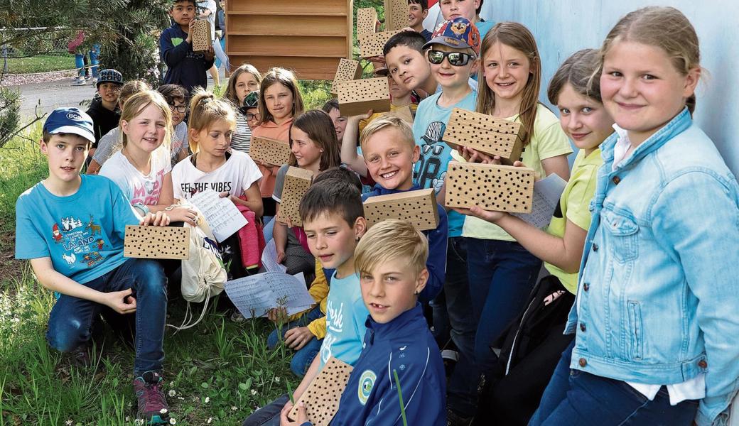 Die Diepoldsauer Erstkommunionkinder mit Diakon Bernd Bürgermeister bei der Einweihung des neuen Wildbienenhotels. 