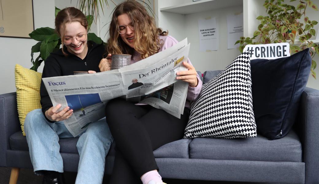 Leonie und Eva beim Couchsurfen und Zeitung lesen.